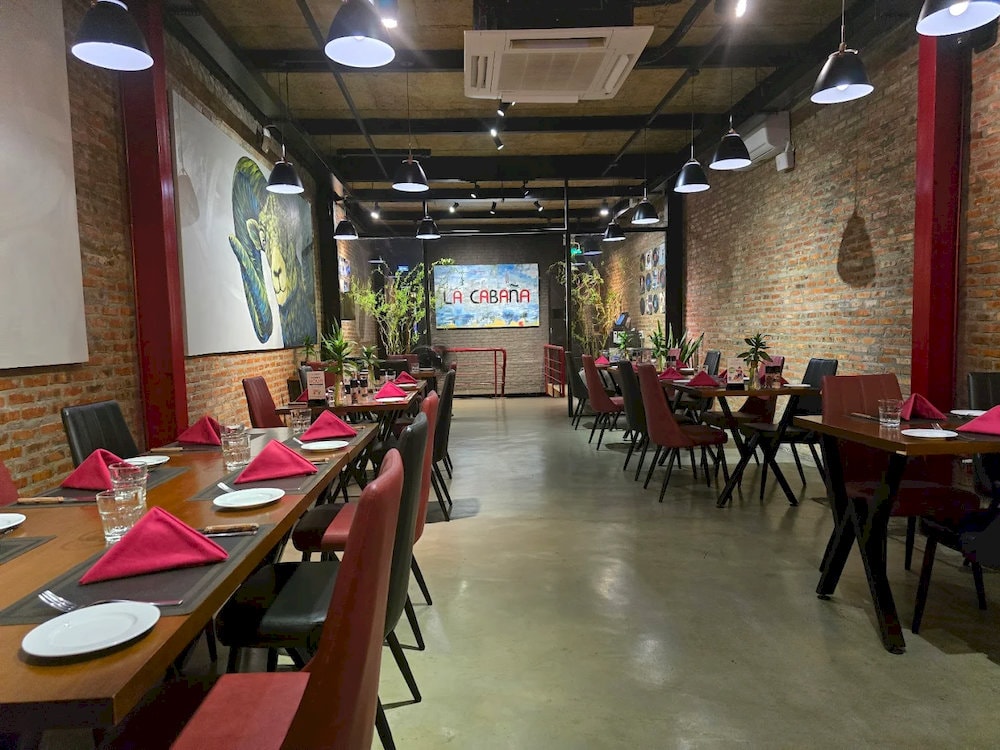 The space reflects Argentine flair with a lively bar and a balcony overlooking the Han River 